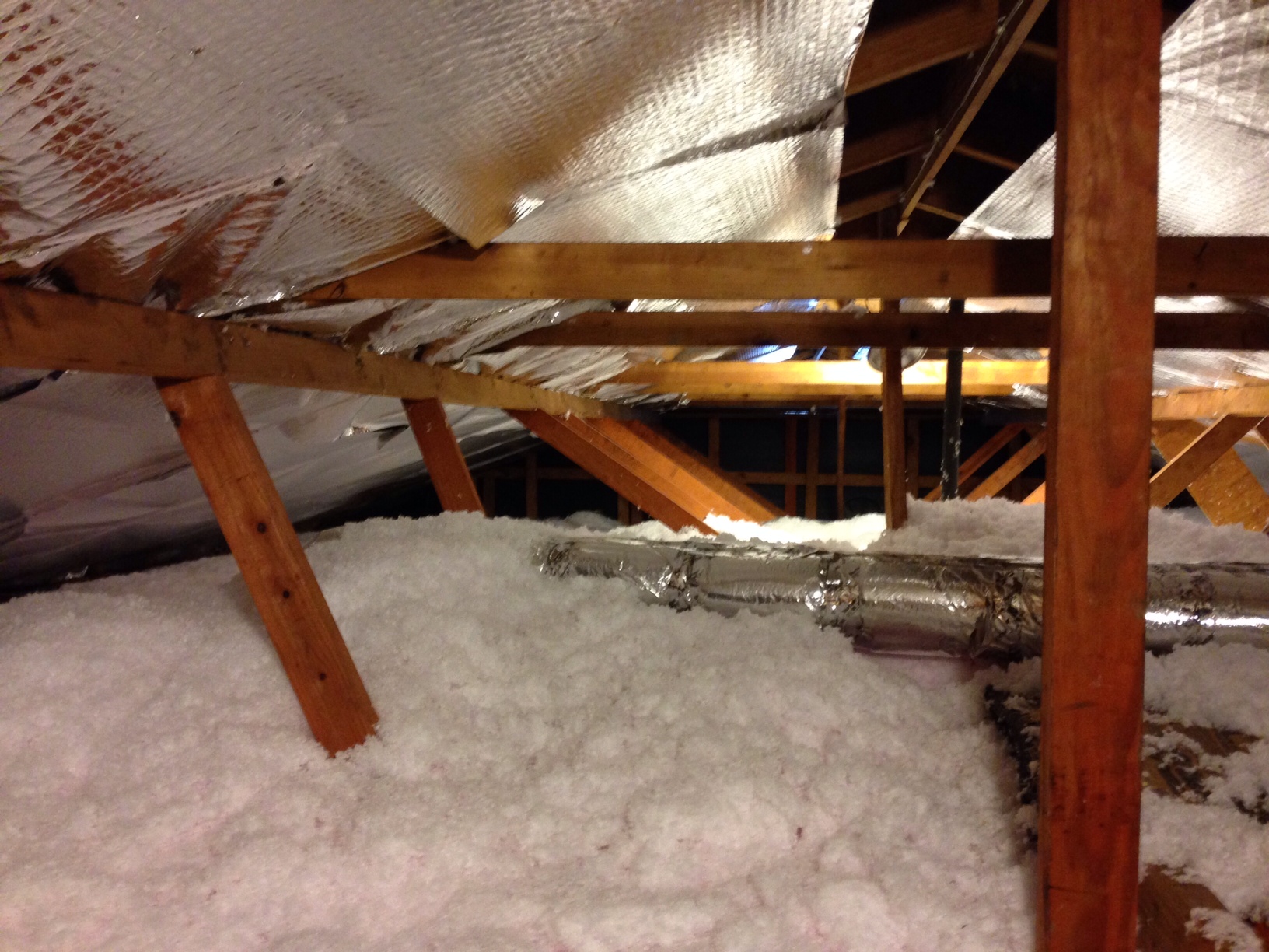 Attic insulation installed between roof joists