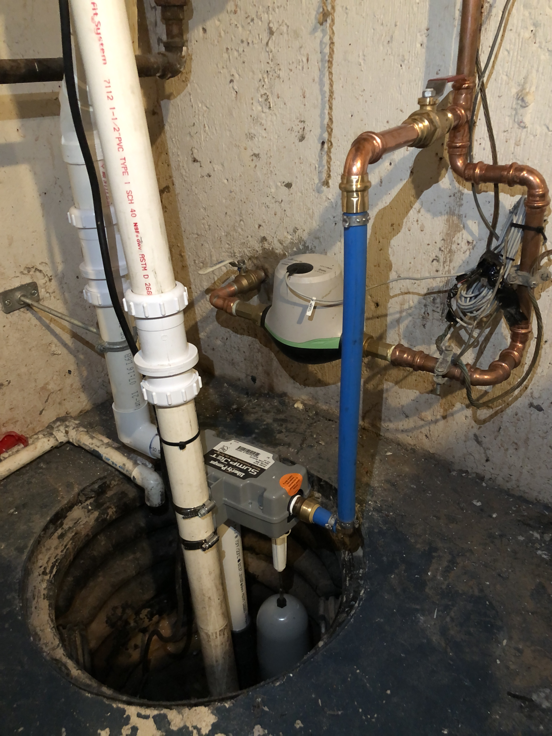 Newly installed sump pump in a home basement