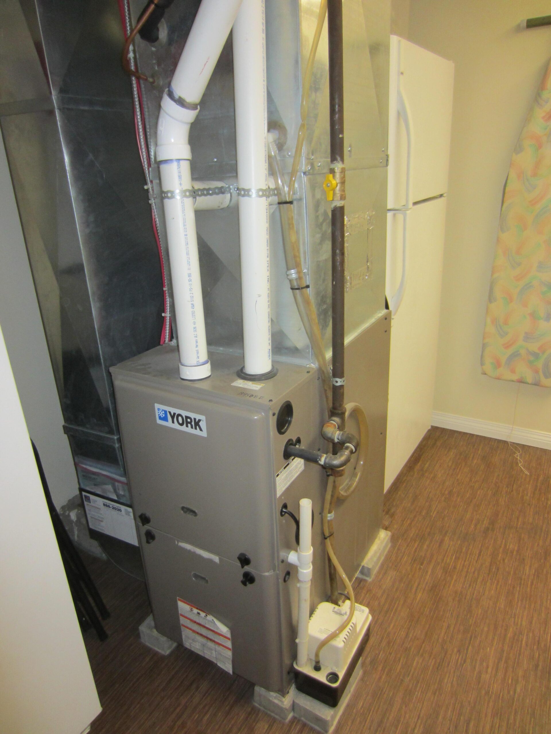 Condensing forced-air gas furnace installed in a home mechanical room